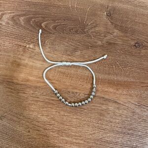 White and silver toned beaded pull tie bracelet​​​​